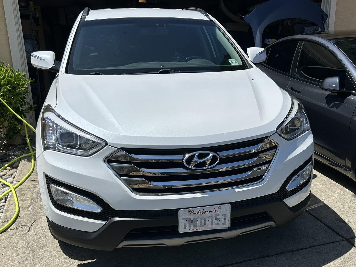 image of a freshly detailed car. The paint reflects the clouds